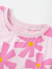 Close-up of pale pink children's t-shirt collar with large pink flower detail
