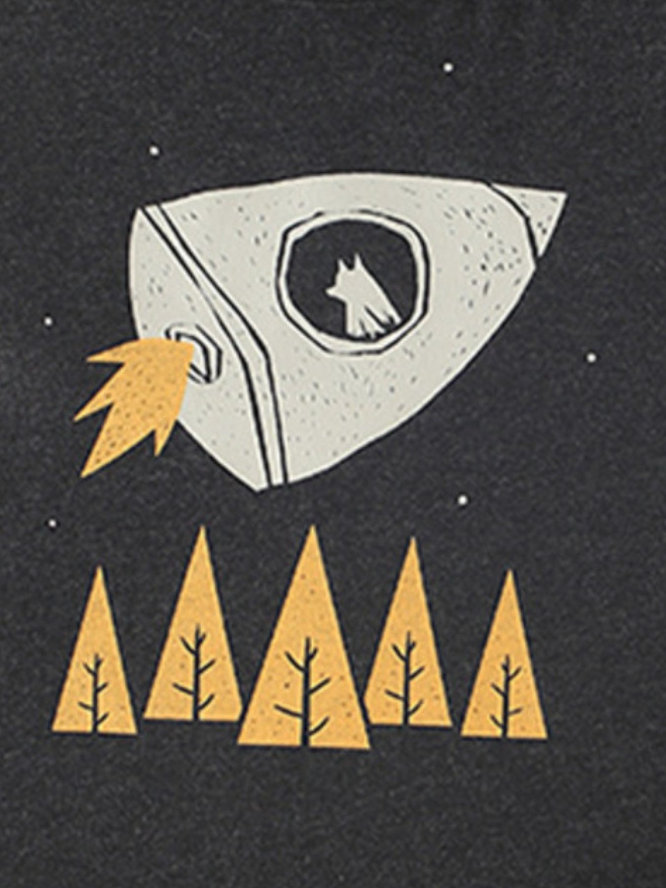 Close-up of white rocket and yellow tree graphic on black children's t-shirt