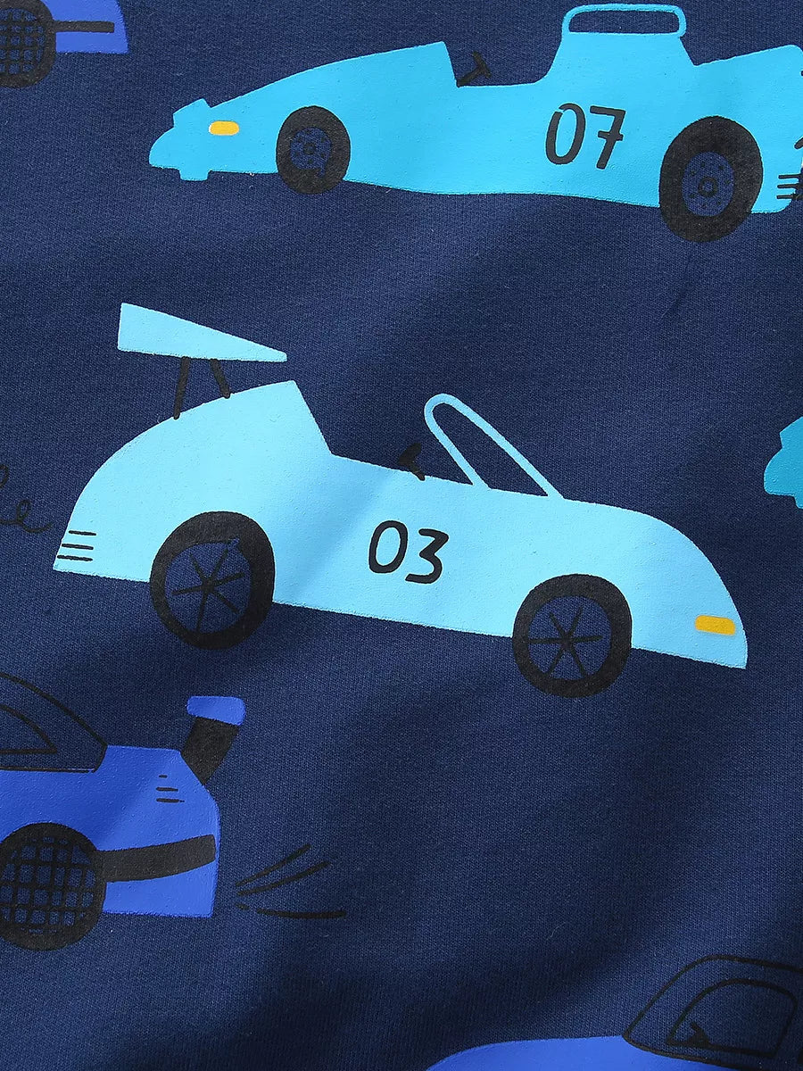 Close-up detail of the light blue racing car print on navy fabric