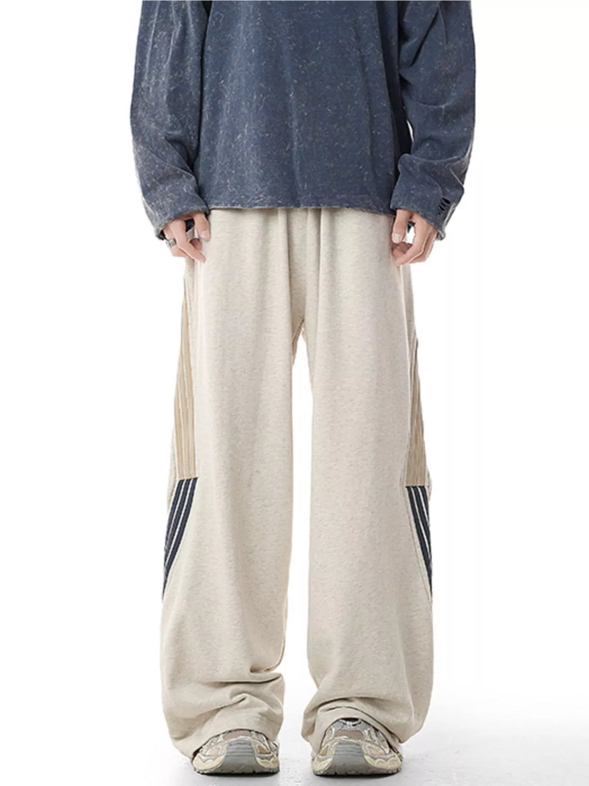 Men's light gray relaxed-fit pants with side stripes and pockets.