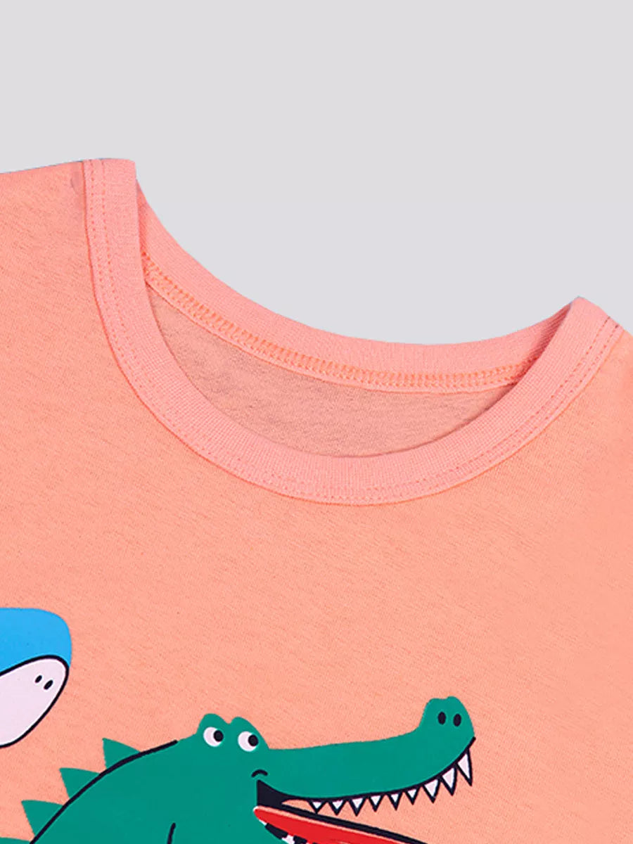 Close up of the pink round neckline and the top of the crocodile graphic