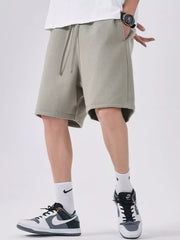 Men's sage casual shorts with a drawstring waist.