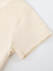 Close up of the cream short sleeve and shoulder stitching on the children's T-shirt