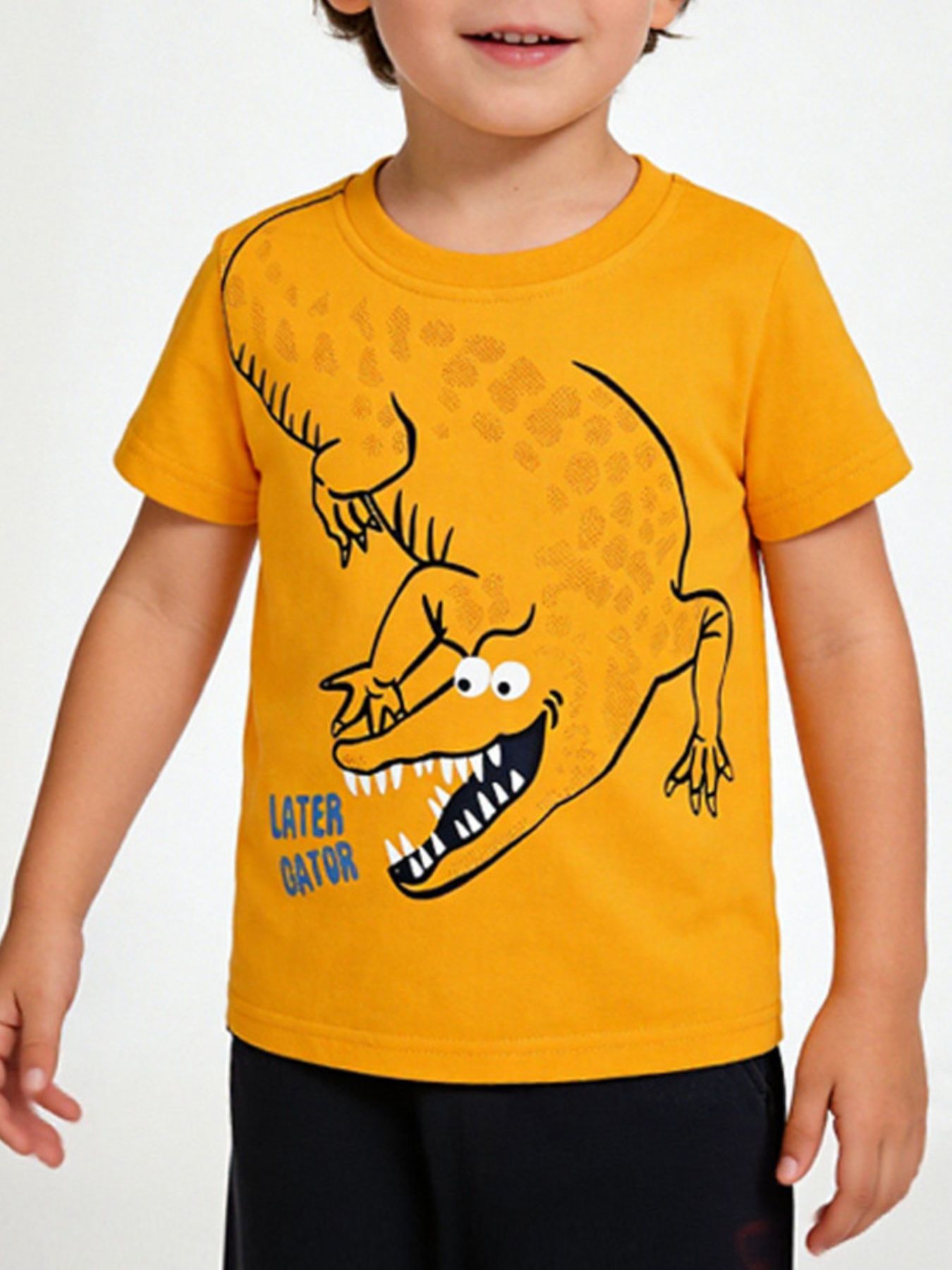 Tangerine children's short sleeve t-shirt with a large cartoon alligator print, shown worn