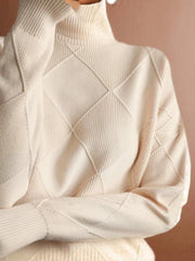 Close up of the cream turtleneck sweater showing its diamond knit texture