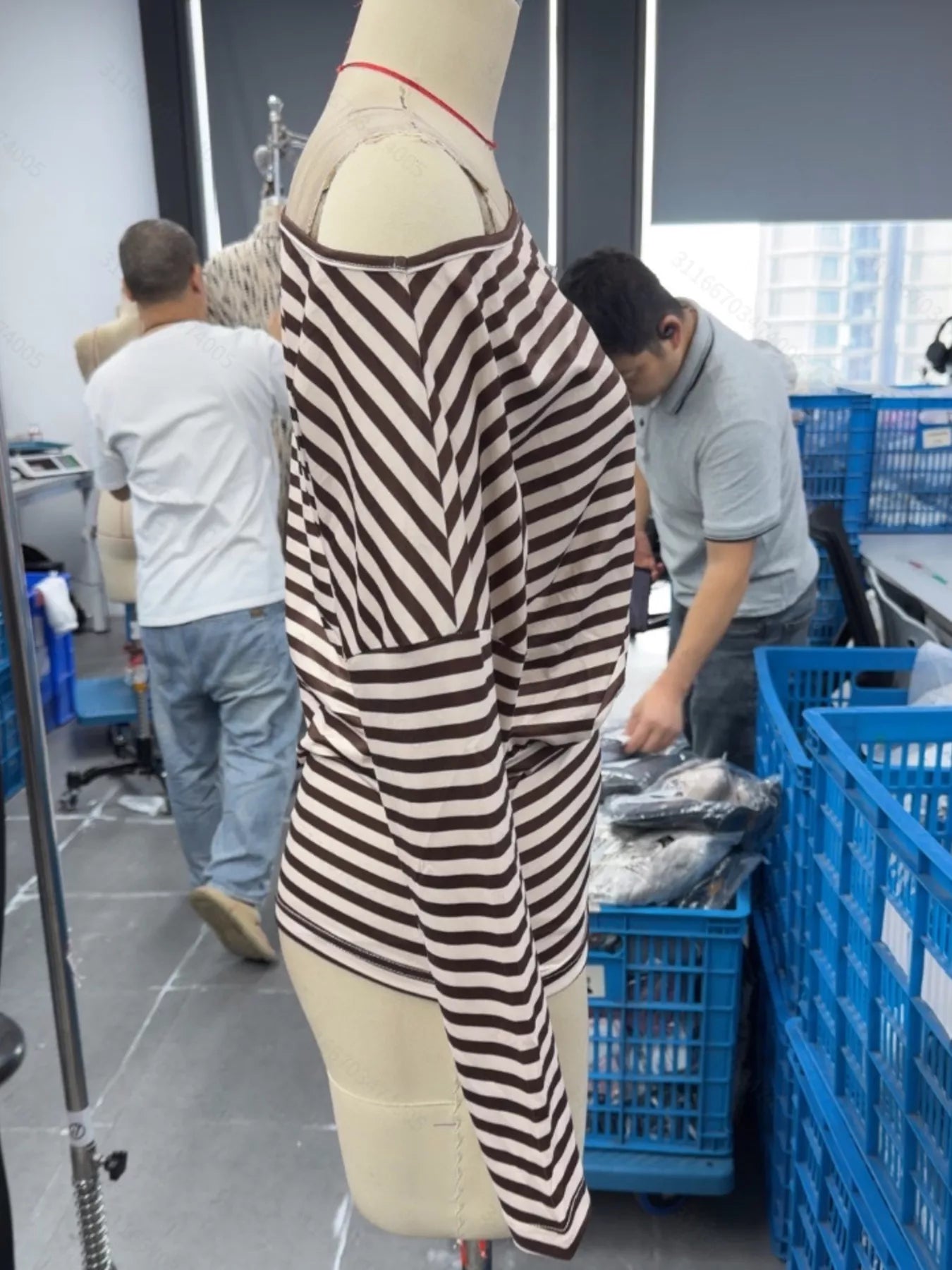 Side view of coffee brown and cream striped one shoulder long sleeve top on mannequin indoors