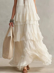 Lower skirt view of white sleeveless maxi dress showing flowing layered ruffle tiers