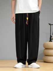 Men's loose fit casual pants with a drawstring waist and pockets.