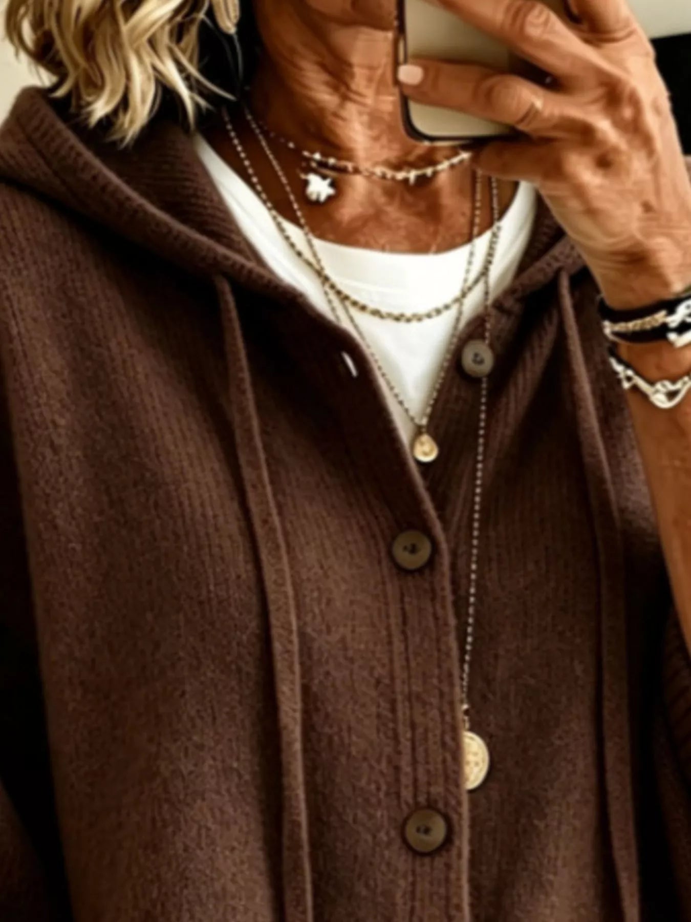 Close view of the dark brown hooded cardigan showing drawstrings and button front