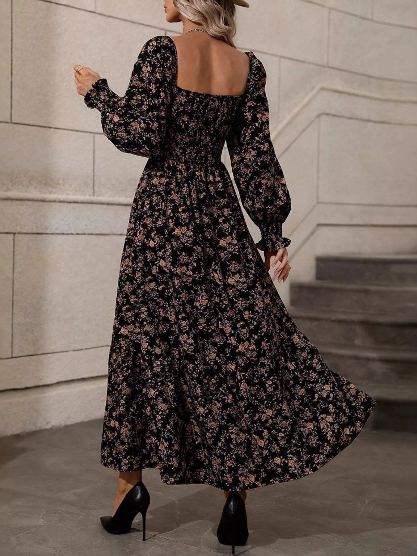 Back view of black floral midi dress with open square back and flowing skirt