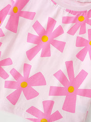 Close-up of pink floral print and hem stitching on light pink children's t-shirt