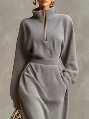 Close front view of a grey waffle knit dress showing the quarter zip collar and waistband