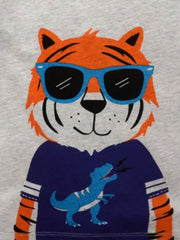 Close-up of the orange tiger face with blue sunglasses and a navy dinosaur shirt