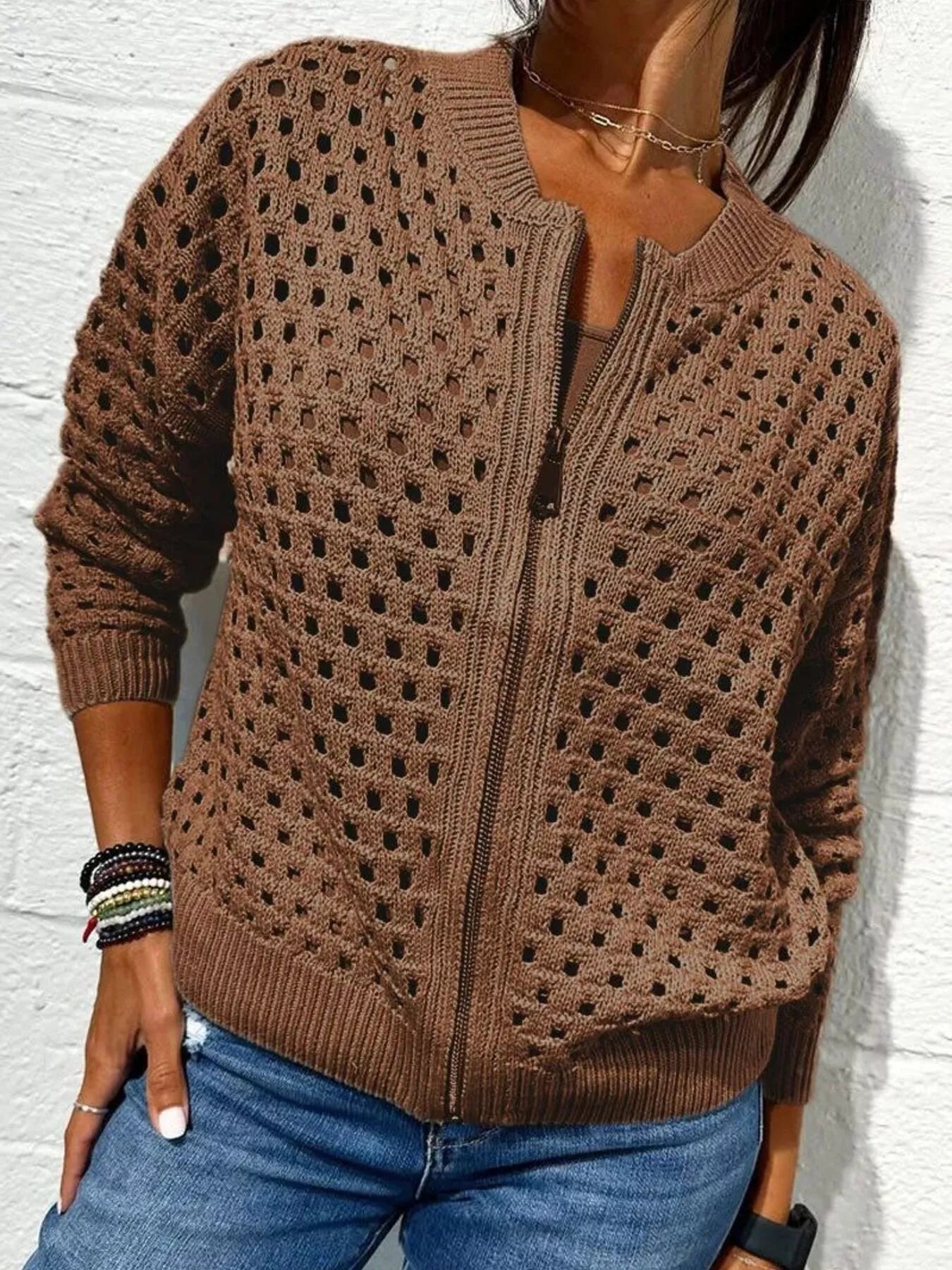 Front view of a dark brown openwork crochet cardigan with a front zip