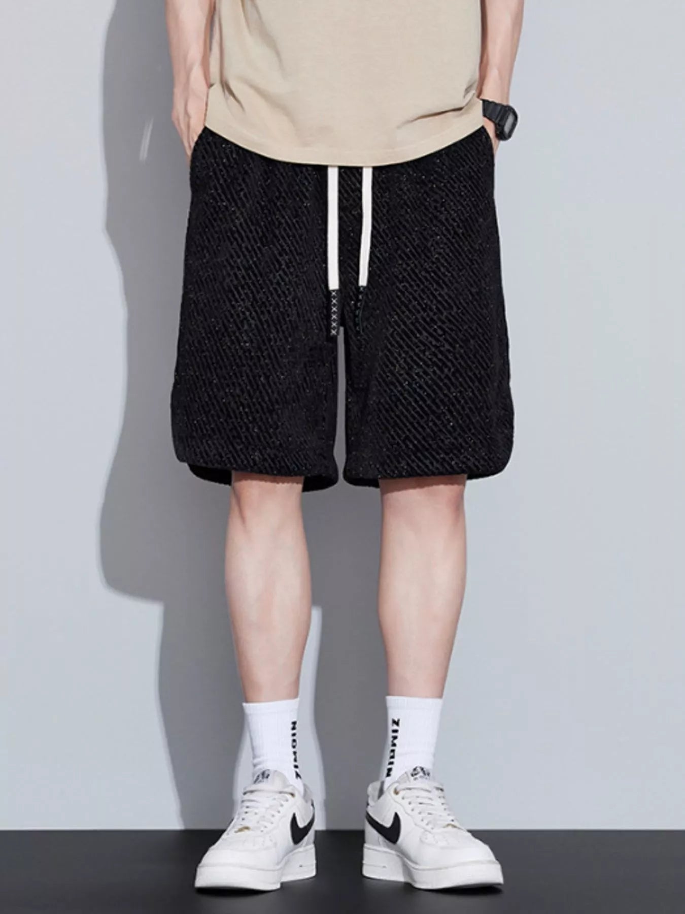 Men's loose fit shorts with a drawstring waist and pockets.