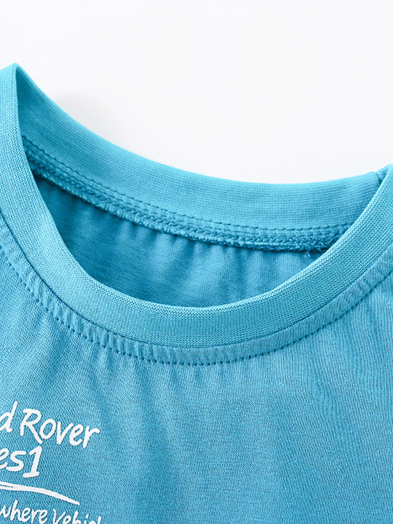 Close-up of cerulean children's t-shirt ribbed crew neckline and neat stitching detail