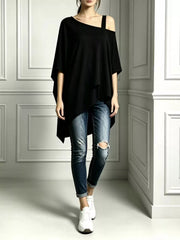 Black asymmetrical-neck short-sleeve tunic top styled with distressed cuffed jeans and white sneakers.