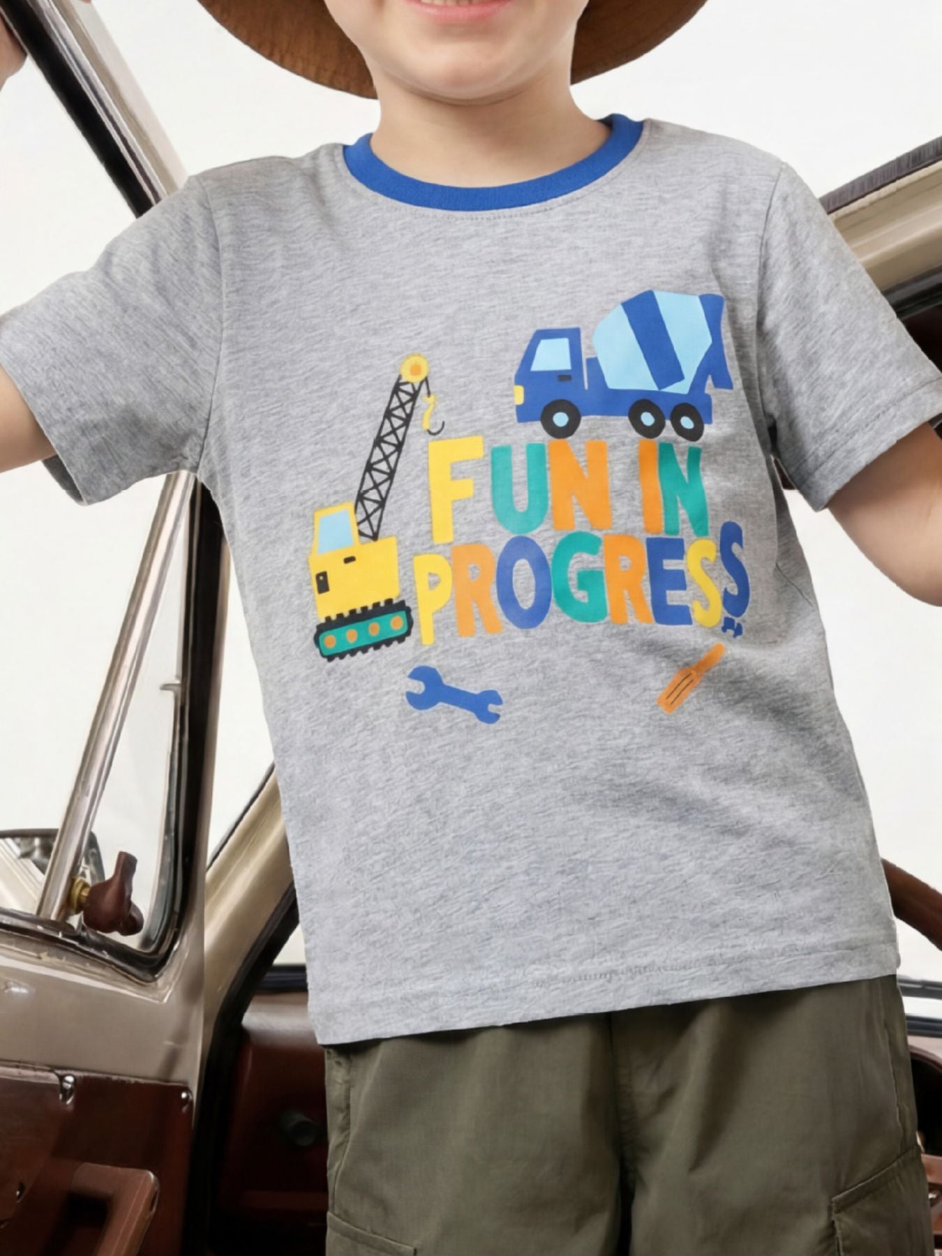 Gray children's t-shirt with construction vehicles and colorful lettering, worn front view