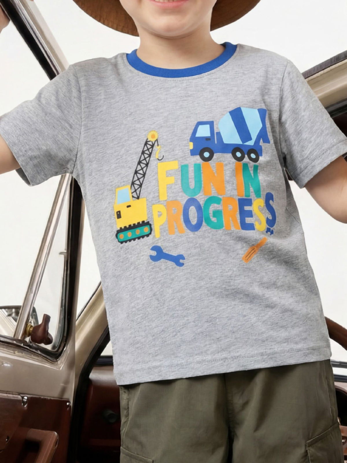 Gray children's t-shirt with construction vehicles and colorful lettering, worn front view
