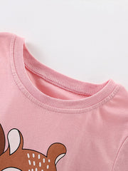 Close-up of blush pink children's t-shirt crew neckline and stitching, with squirrel graphic below