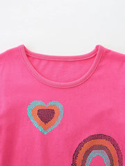 Close up of the round neckline and sequin heart on a hot pink children's rainbow tee