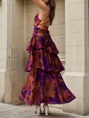 Back view of a deep purple floral maxi dress with an open lace up back and tiered ruffles