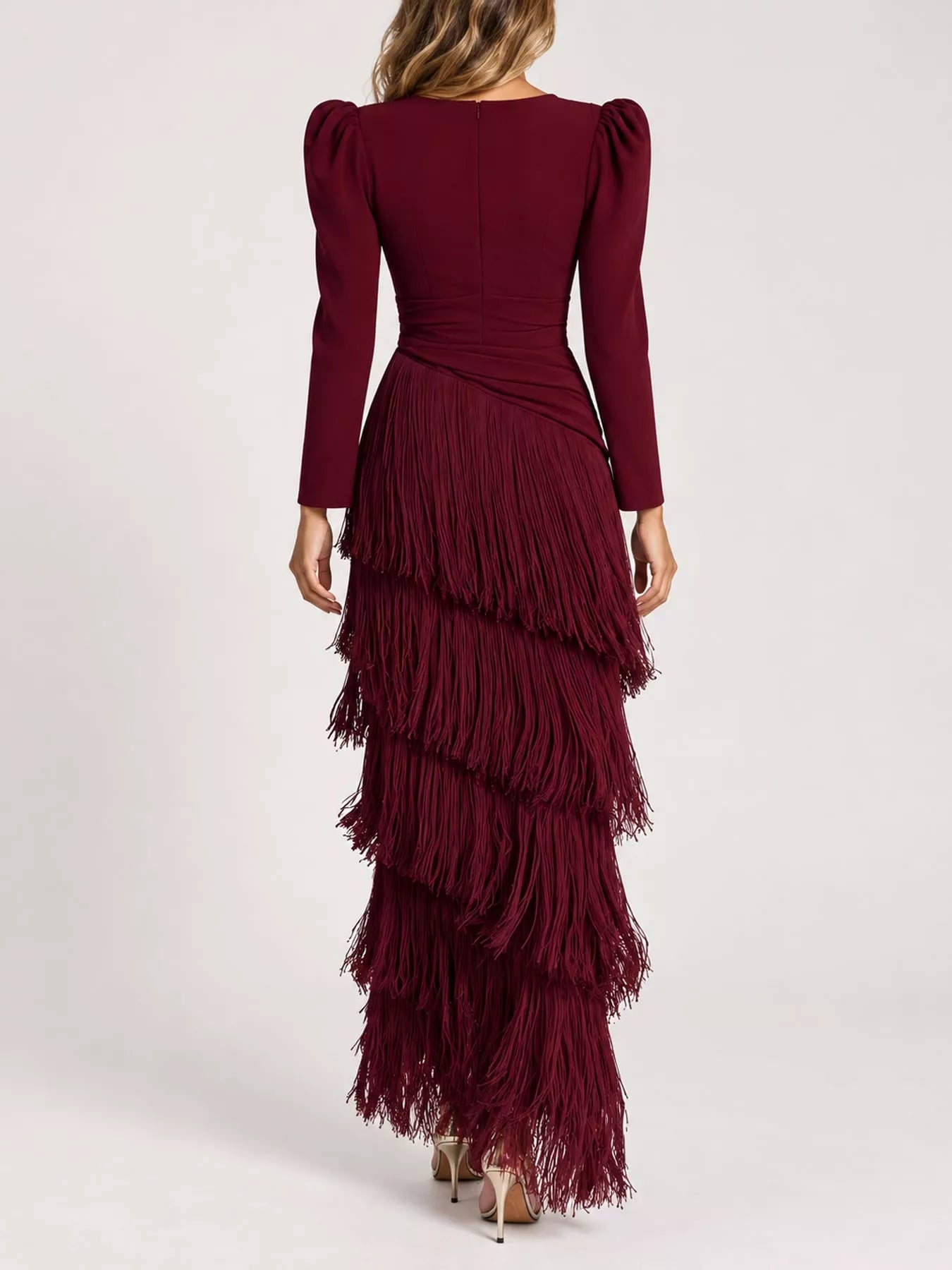 Studio back view of a burgundy fringed maxi dress with tiered fringe layers