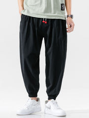 Men's loose fit joggers with a drawstring waist and pockets.