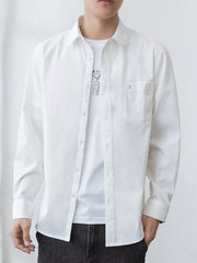 Men's oversized long-sleeve button-up shirt with pockets in a cotton-spandex blend.