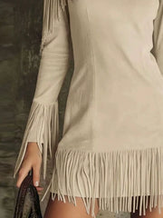 Close detail of the apricot fringed cold shoulder mini dress hem and sleeve fringe