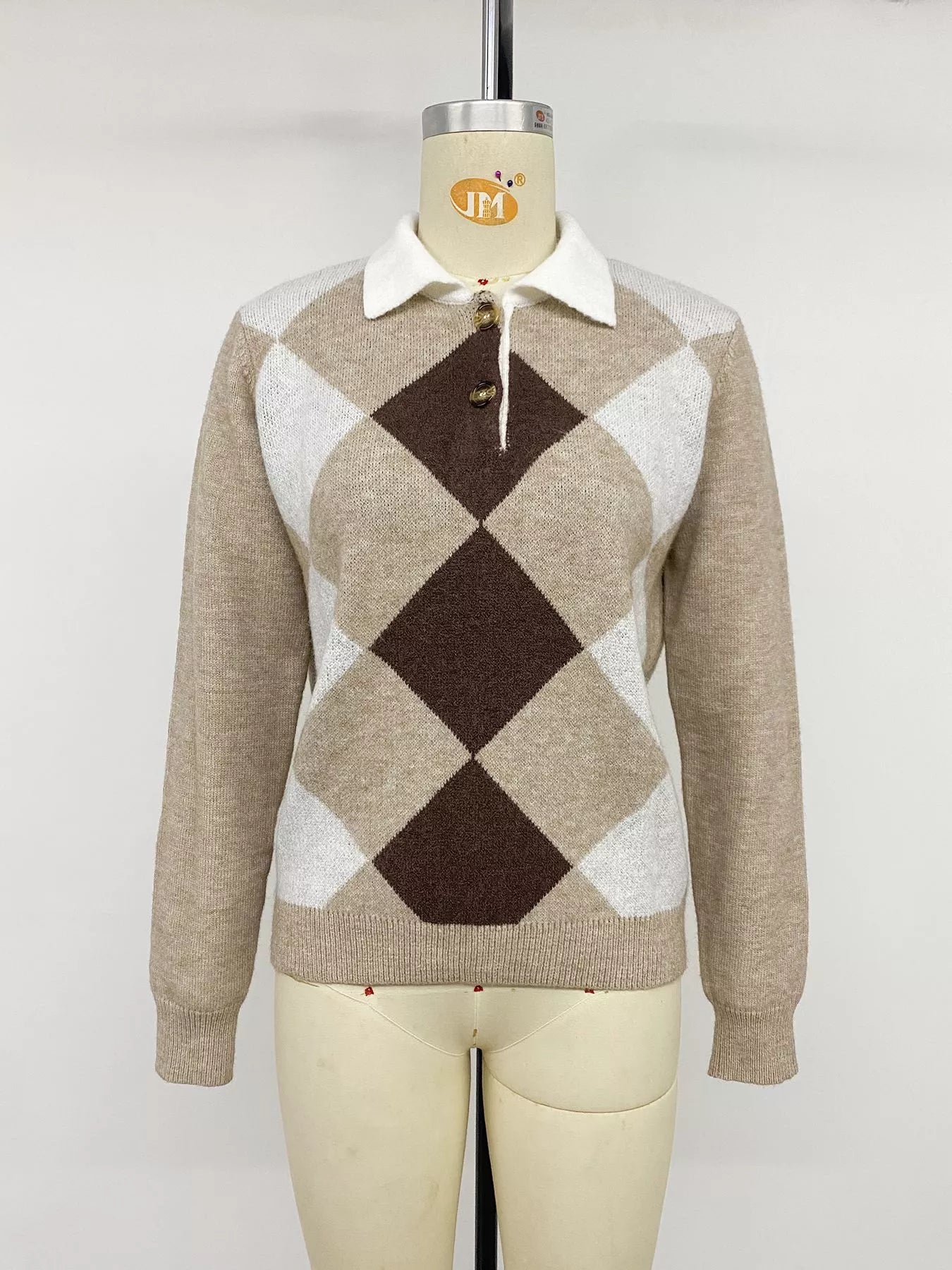 Front view of the beige, brown, and white argyle polo sweater on a mannequin