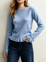 On-model front view of light blue crew neck sweater with ruffled hem and cuffs
