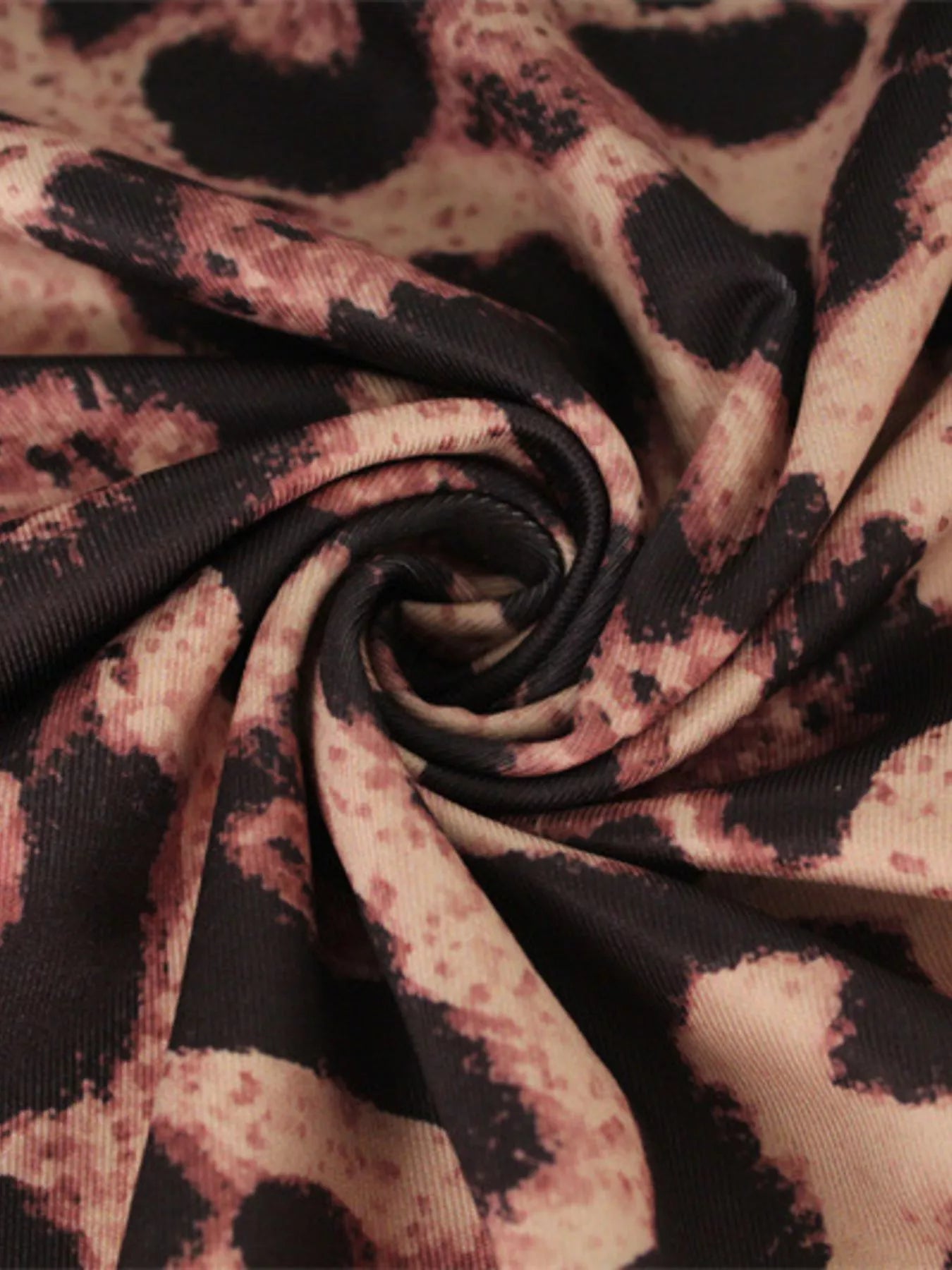 Close up swirl detail of the leopard print fabric on the bodycon midi dress