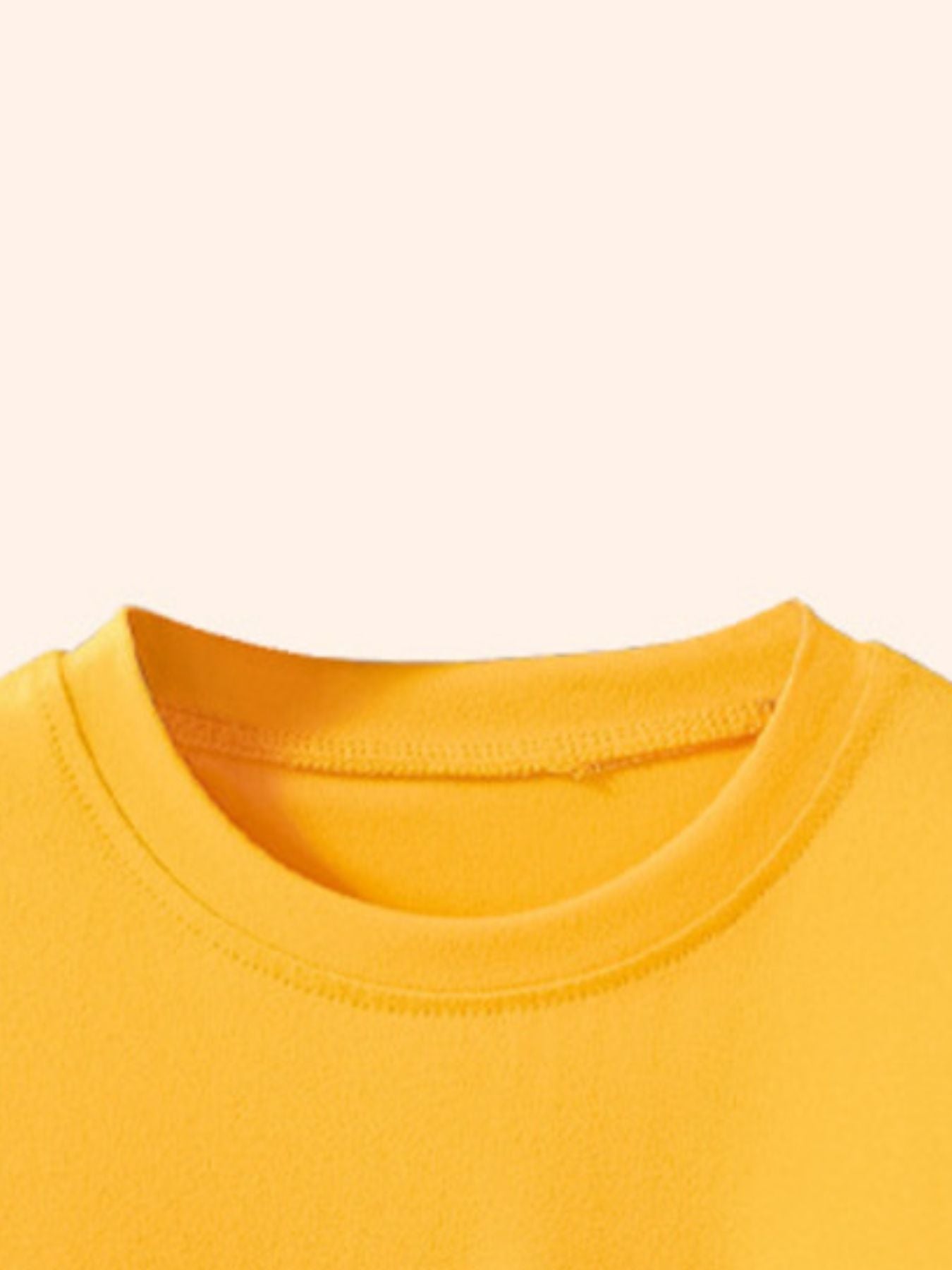 Close view of the gold children's tee round neckline showing neat stitching and soft fabric