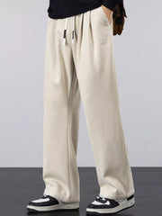 Men's khaki lightweight loose-fit pants with a drawstring waist and pockets.