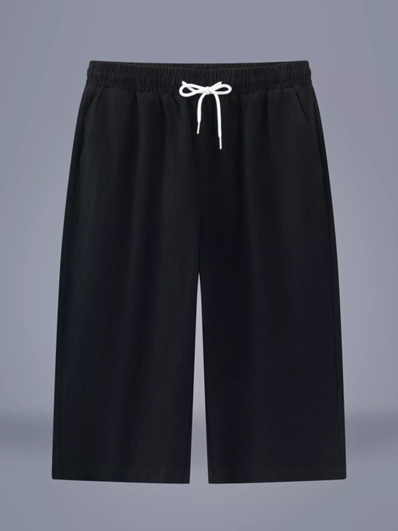 Men's black cropped casual pants with a drawstring waist and pockets.