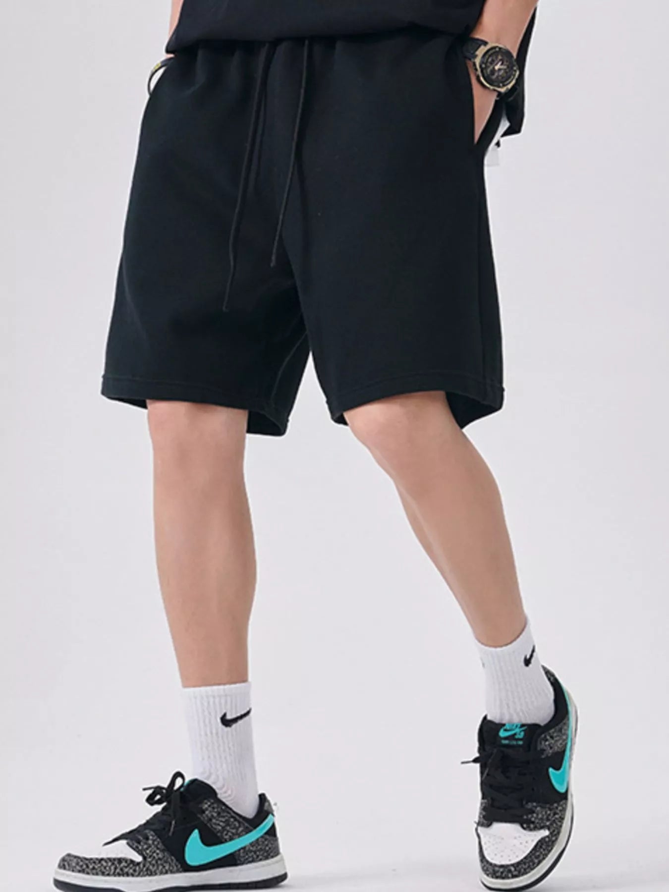 Men's black casual shorts with a drawstring waist.