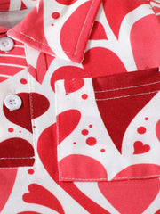 Close detail of the chest pocket and button placket on a red heart print children's polo