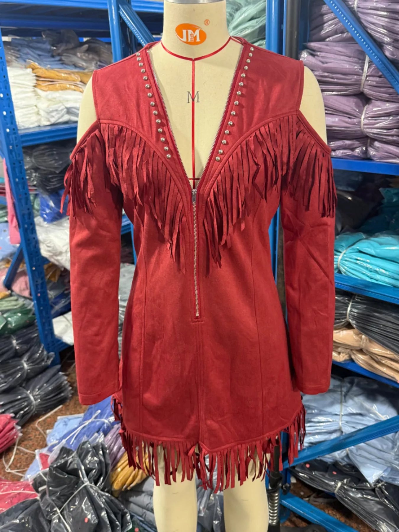 Red fringed cold shoulder mini dress on mannequin showing zip front and fringe