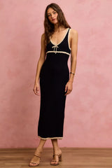 Black and oatmeal sleeveless knit sweater maxi dress in front view with relaxed pose