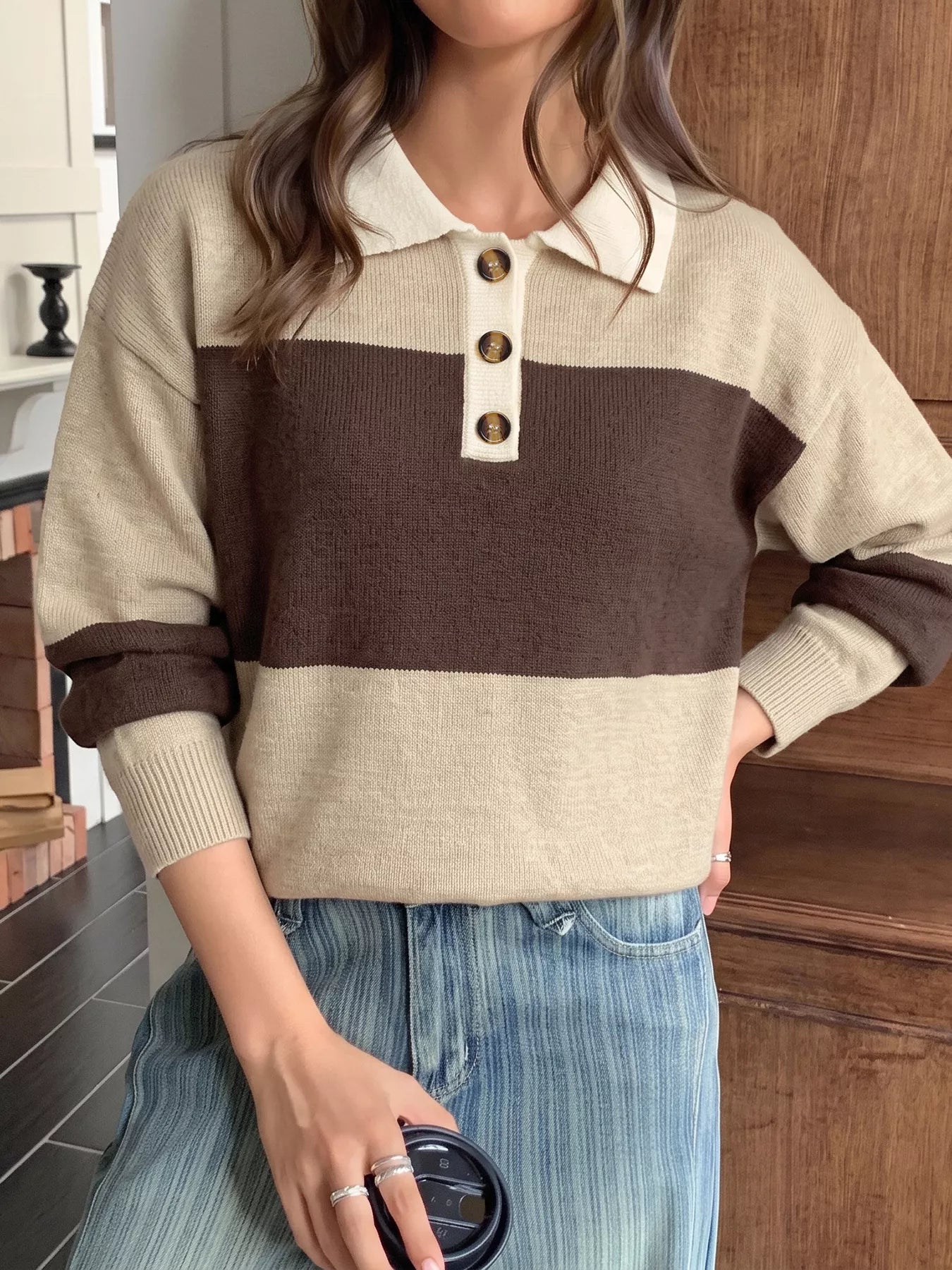Front view of beige and brown color block polo sweater with cream collar.