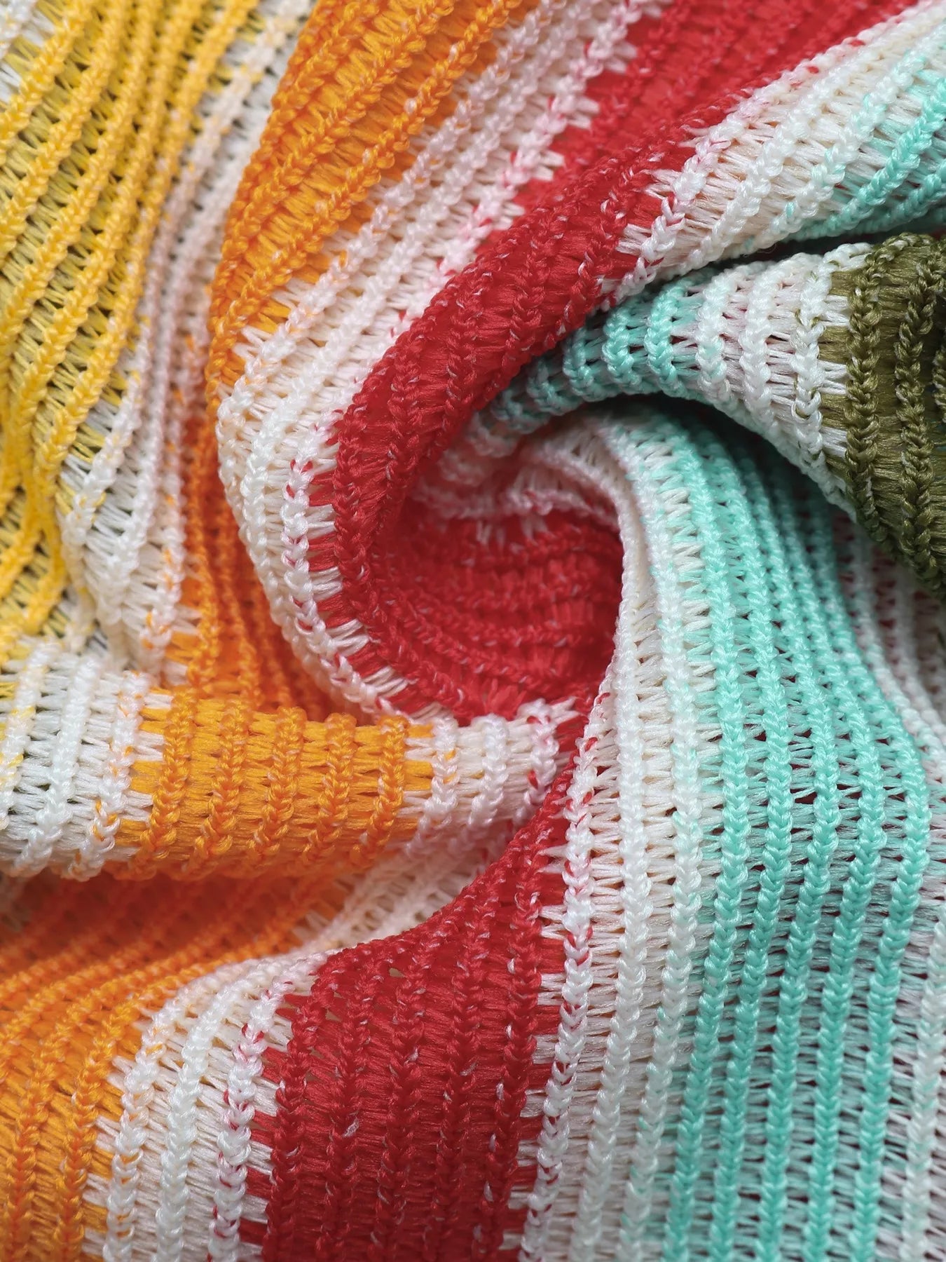 Close texture view of striped knit fabric in yellow orange red white and mint