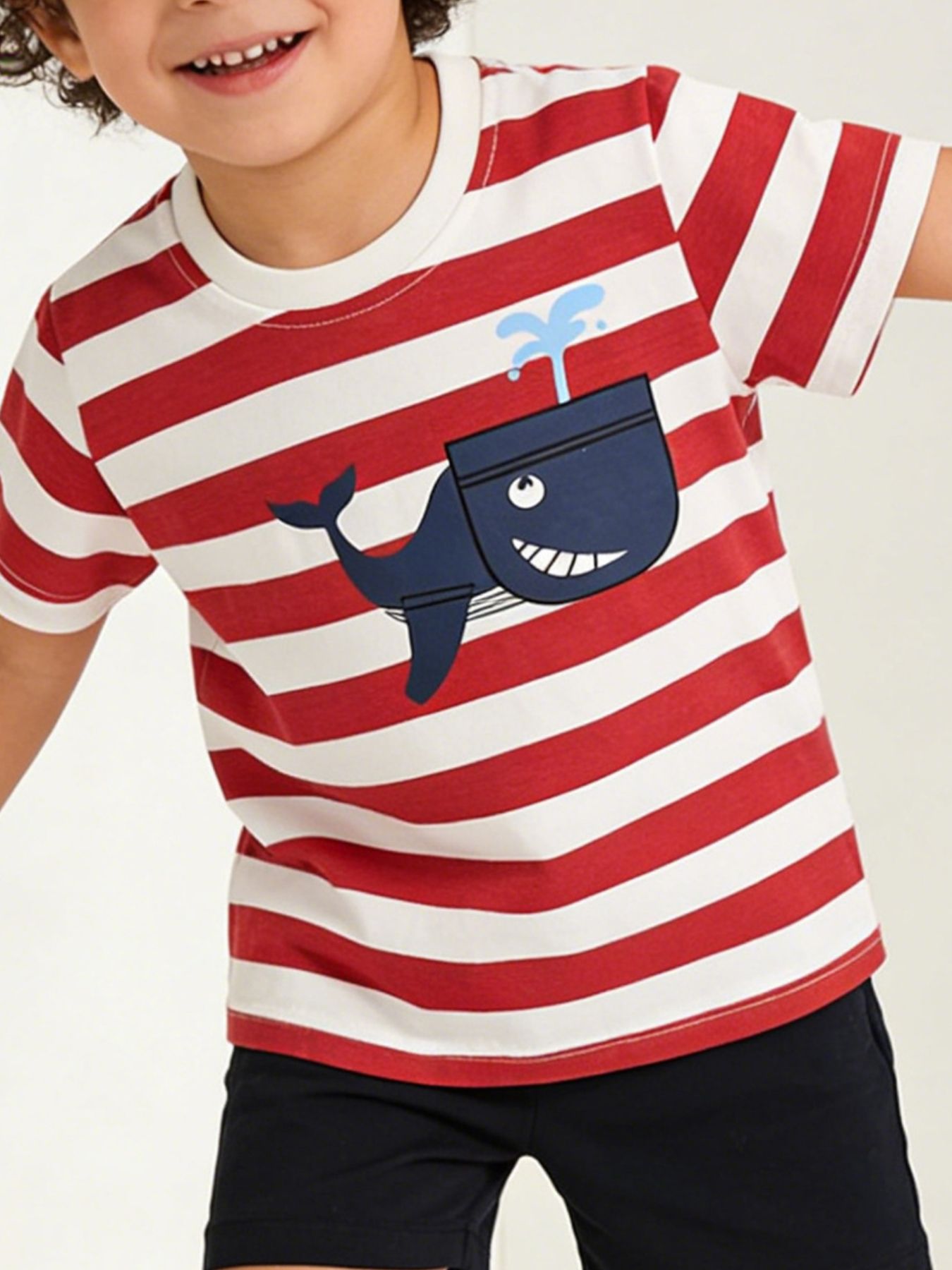 Children's red and white striped t-shirt worn in front view with navy whale graphic