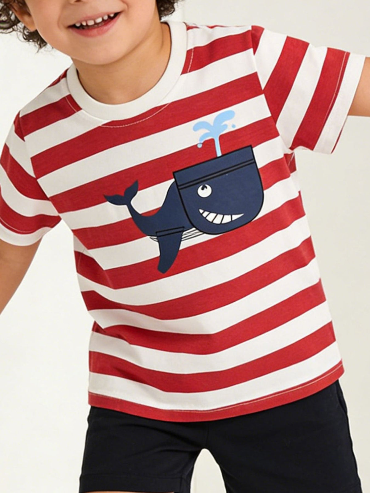 Children's red and white striped t-shirt worn in front view with navy whale graphic