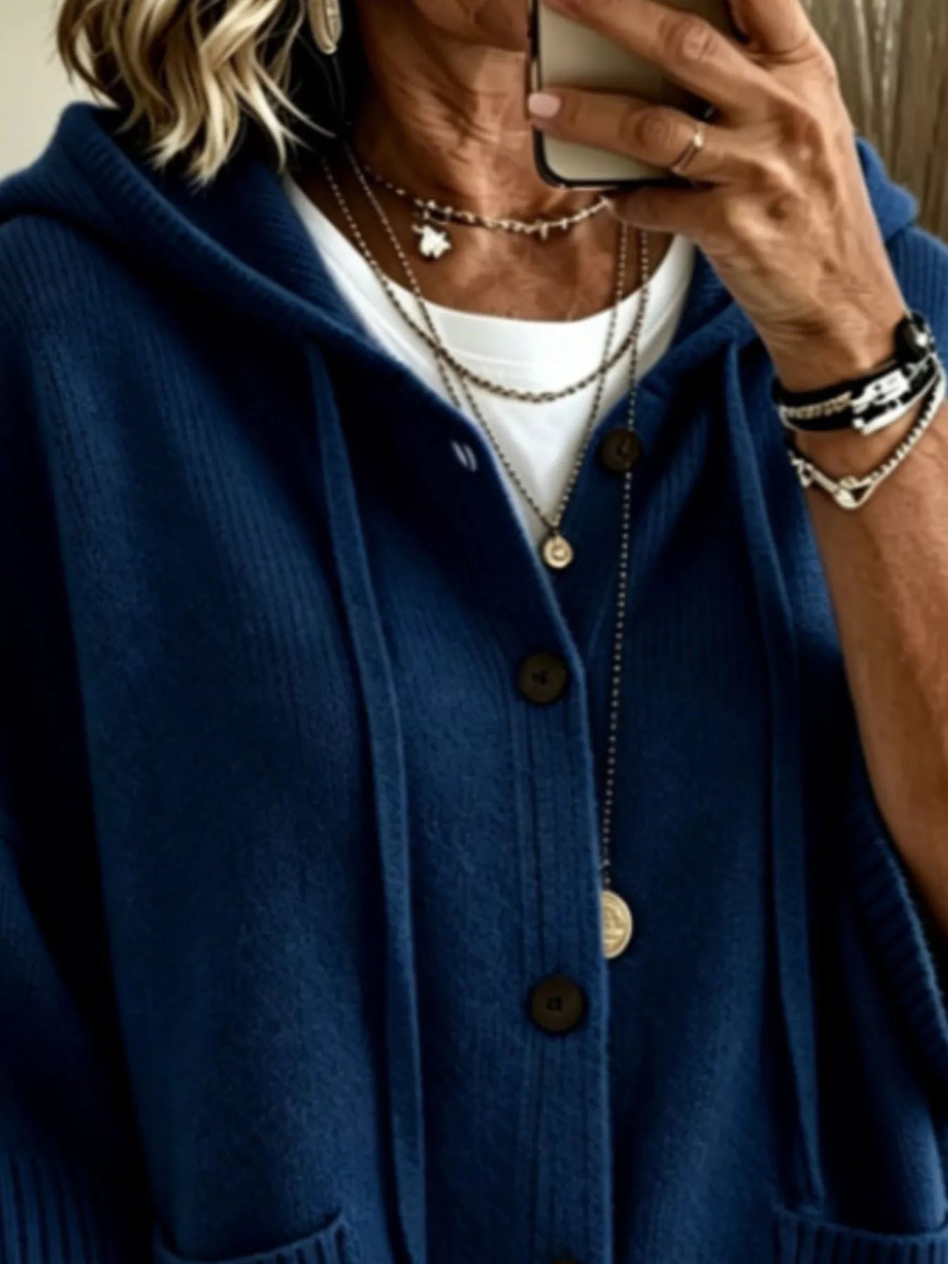 Close view of the navy hooded cardigan showing drawstrings and button front