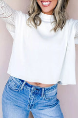 Front view of a white ribbed mock neck top layered over lace long sleeves