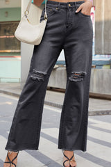 Women's loose-fitting jeans with distressed detailing, buttons, and pockets.