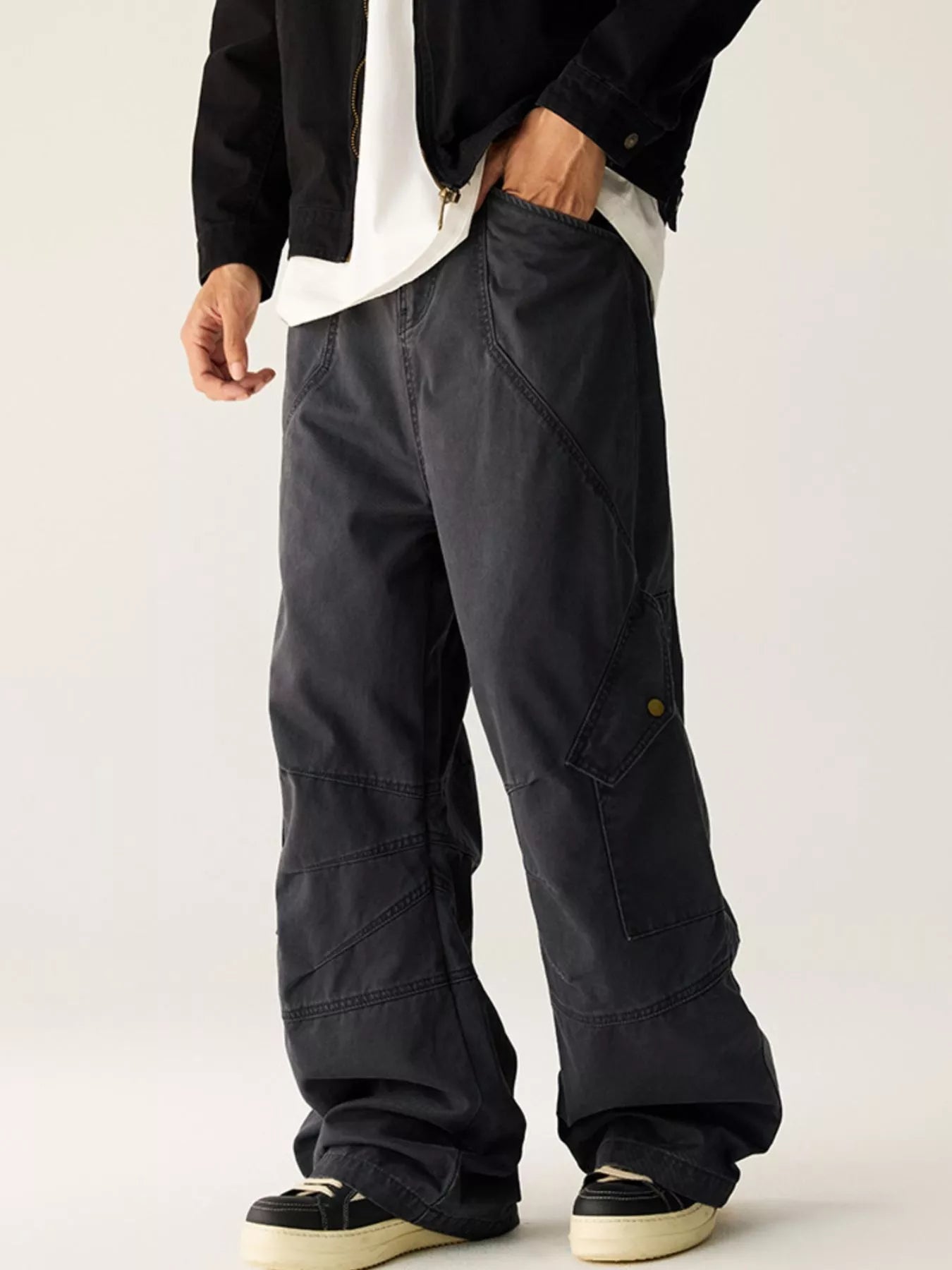 Men's dark gray wide leg cargo pants with pockets.