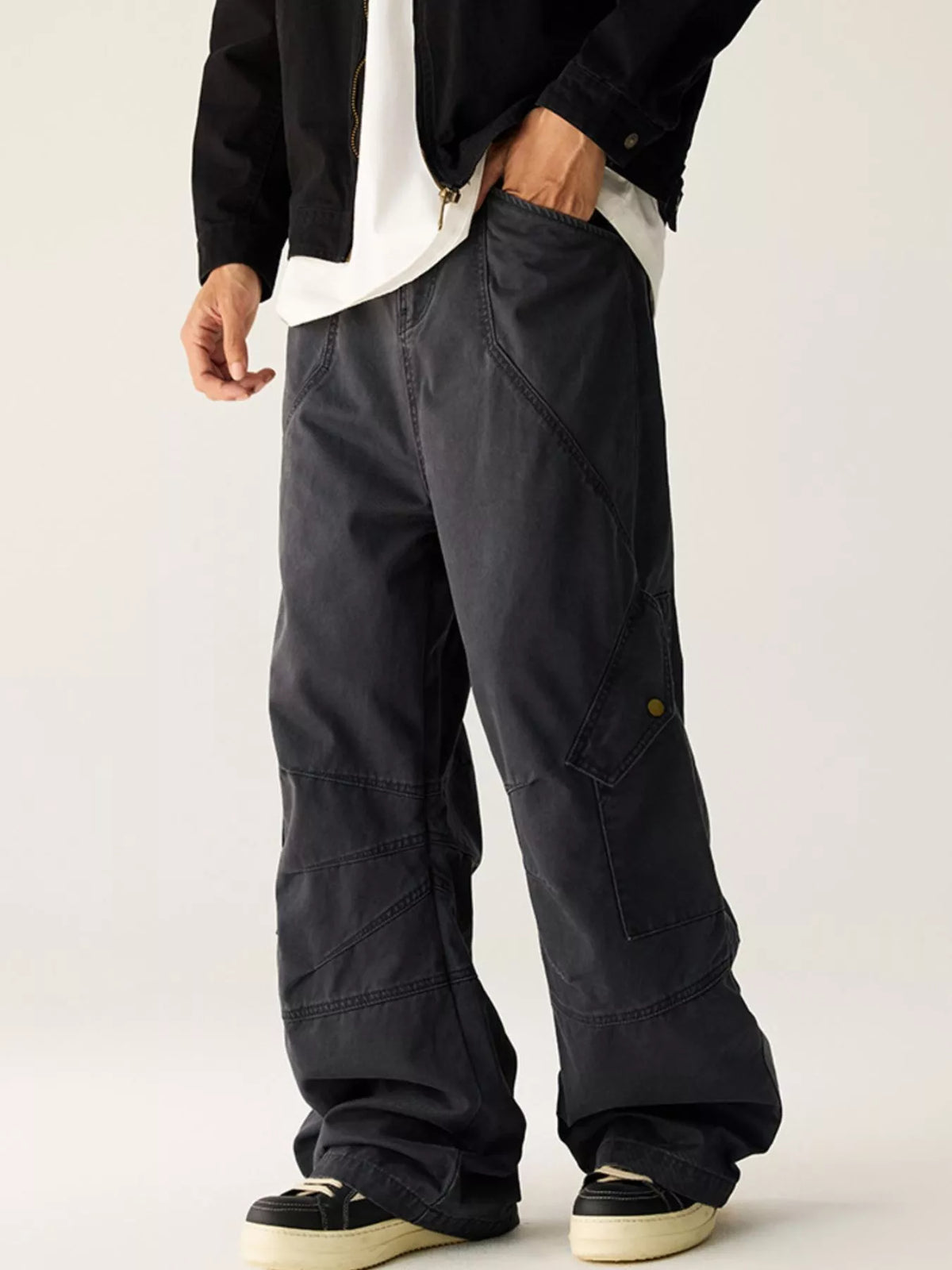 Men's dark gray wide leg cargo pants with pockets.