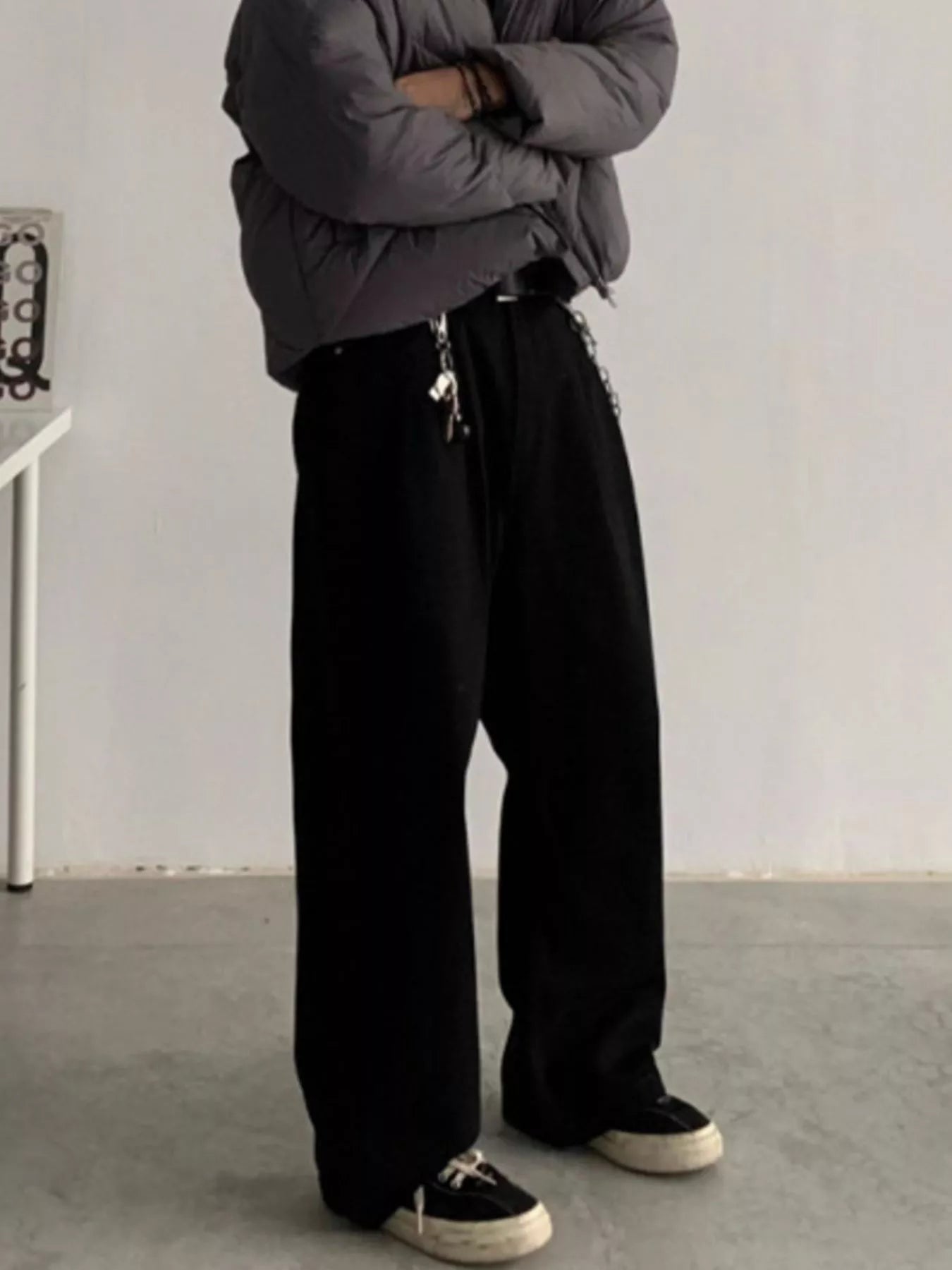 Men's black loose-fit casual pants with pockets.